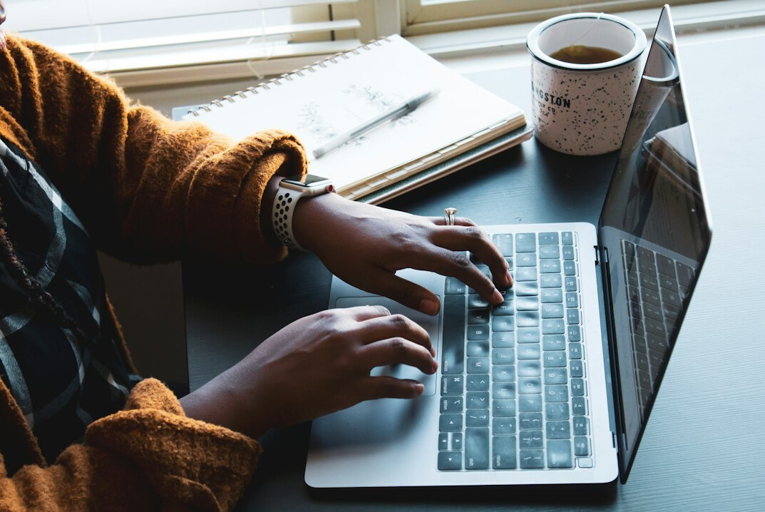 author typing on laptop